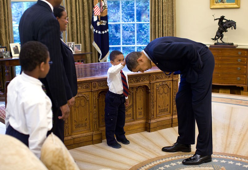 Kid rubs Obama's head