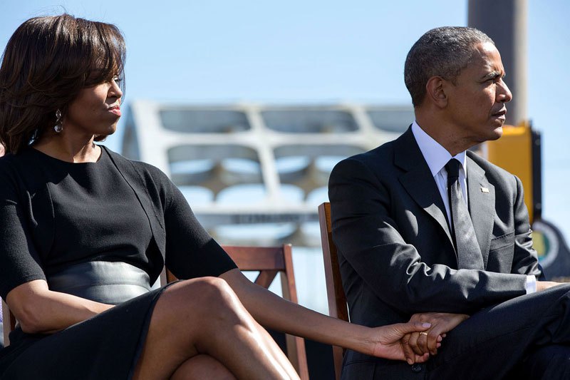 Barack holds Michelle's hand