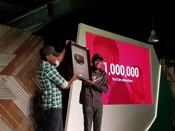 Mark Angle receiving plaque for reaching 1 million subscribers on YouTube