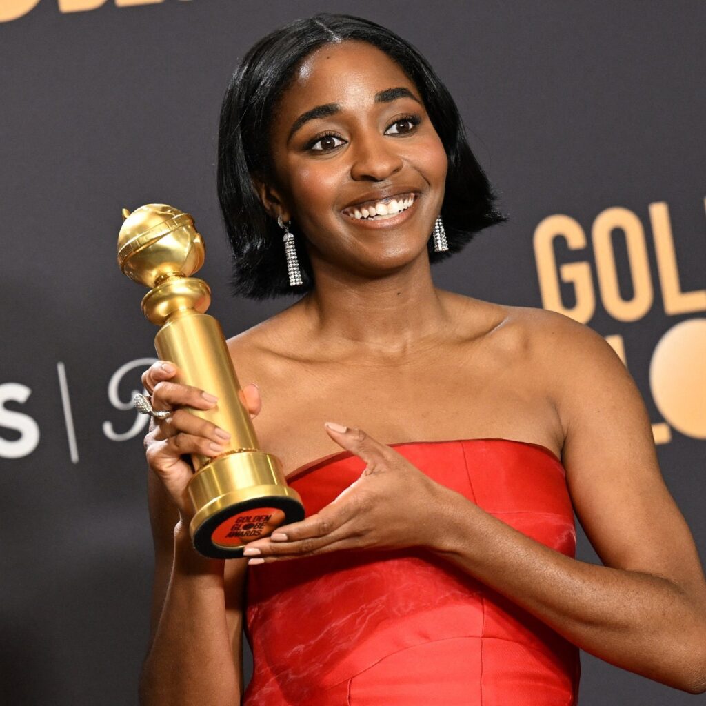 Ayo Edebiri winner in the Best Performance by a Female Actor in a Television Series – Musical or Comedy posing with her Golden Globe Awards
