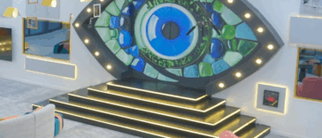 An image of the Big Brother Naija (BBNaija) Season 10 house interior. The image features a large, illuminated eye symbol on a wall above a black and gold staircase. The text below the image reads: “Top 10 BBNaija S10 Moments That Broke The Internet Last Week,” with the source URL listed as “www.lists.ng.