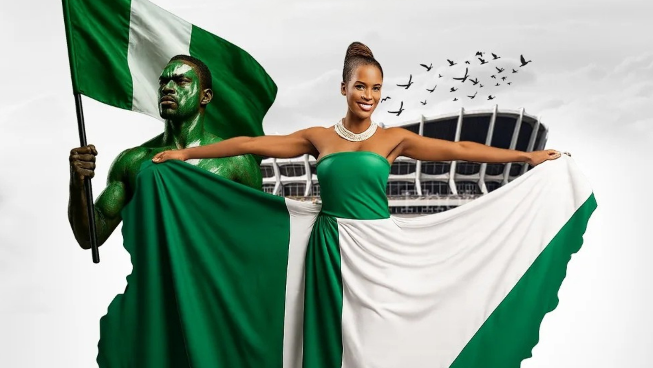 A vibrant image featuring a man and a woman holding a large Nigerian flag, with green and white colors flowing around them. The man, painted green, holds a flagpole on the left, while the woman, dressed in a green strapless dress and pearl necklace, stands with arms outstretched on the right. In the background, a stadium and flying birds are visible against a light sky.