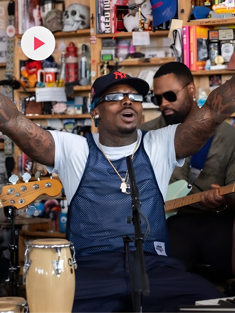 Asake singing with his hands in the air at NPR Tiny Desk Concert