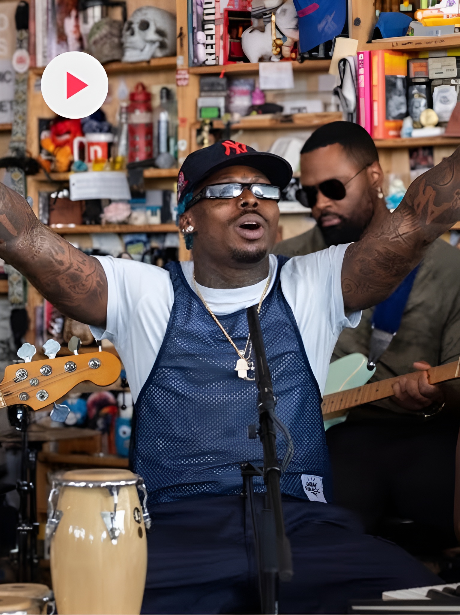 Asake singing with his hands in the air at NPR Tiny Desk Concert